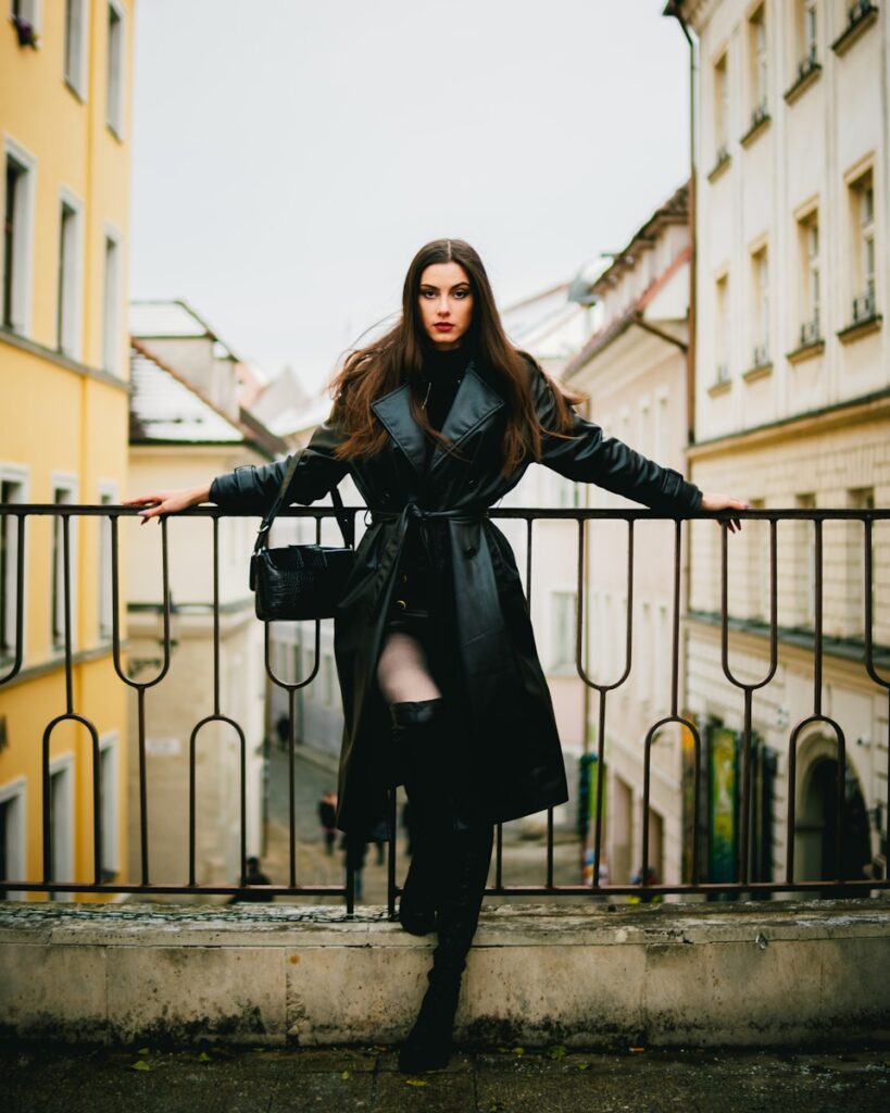 a woman standing on a balcony with her arms outstretched