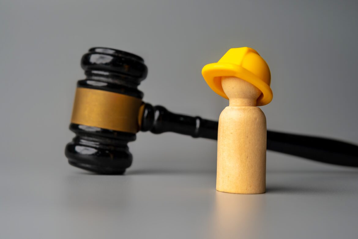 a-wooden-doll-wearing-a-hard-hat-stands-in-front-o-2025-03-16-19-31-58-utc Novi Zakon o radu